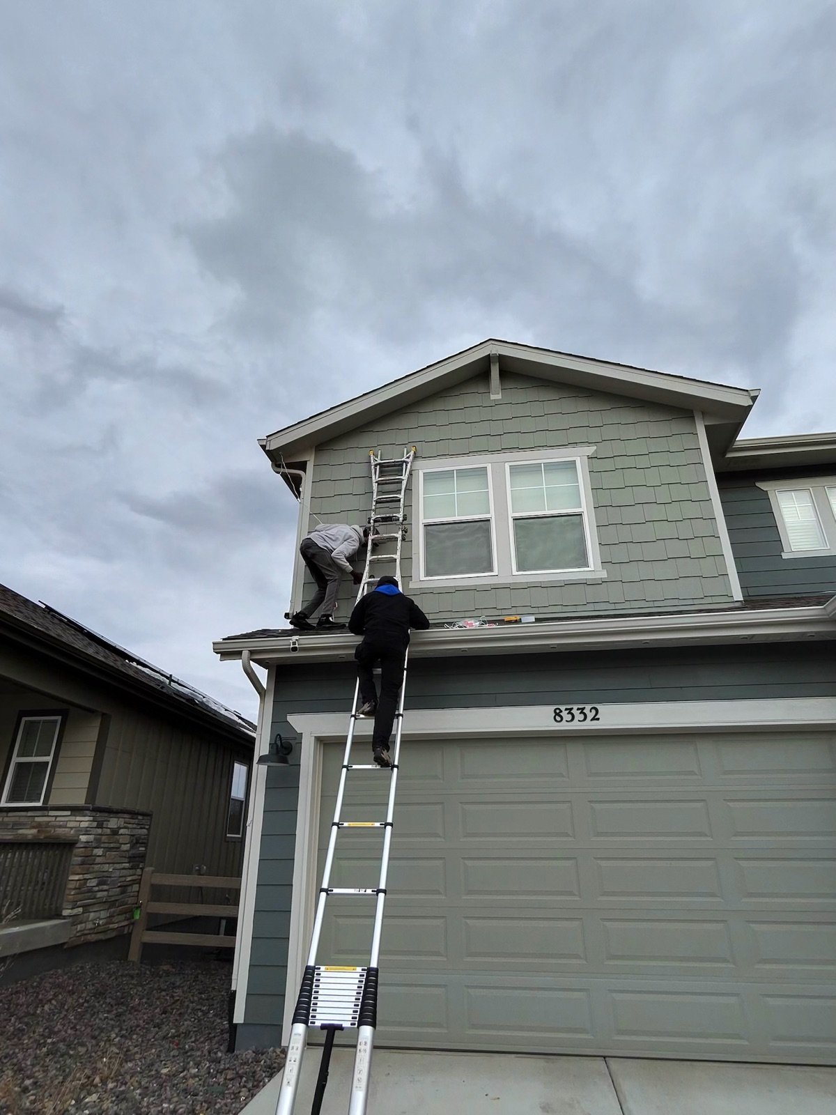 Professional holiday light installation from a ladder